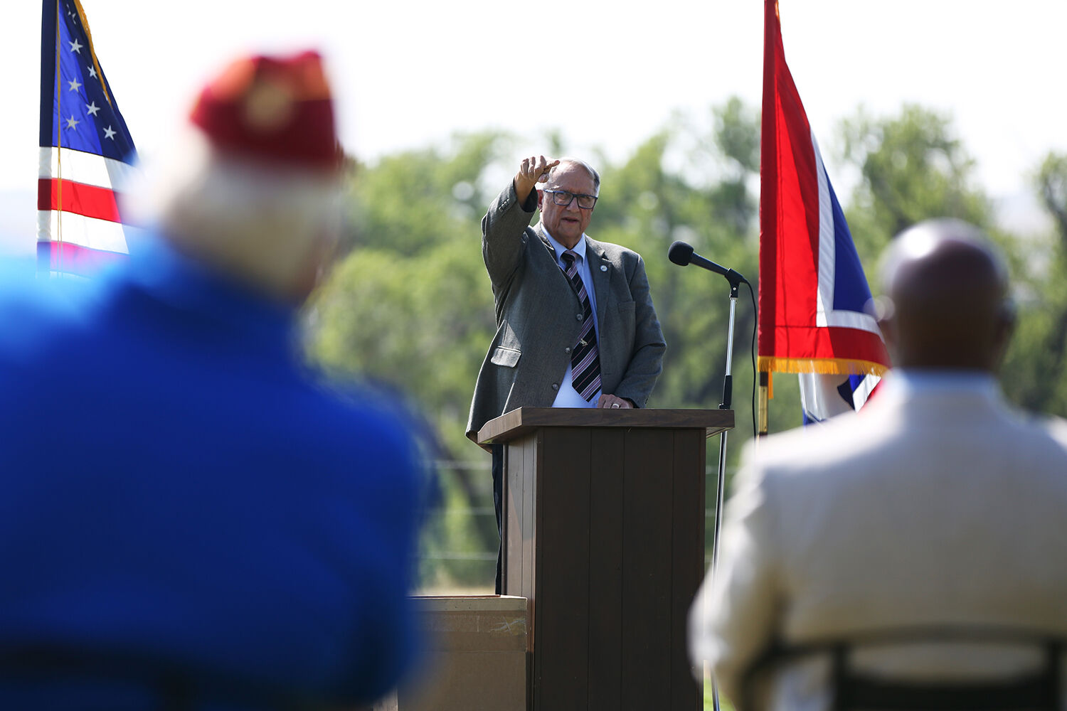 Col. Jack Tarter lifts his hand during his speech